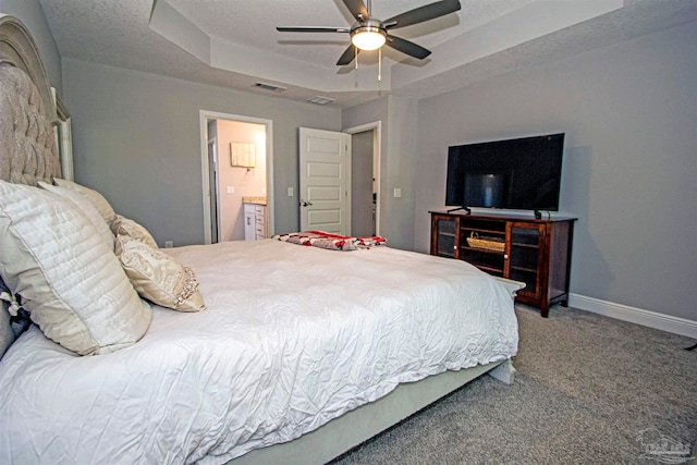 bedroom with connected bathroom, ceiling fan, carpet, and a textured ceiling