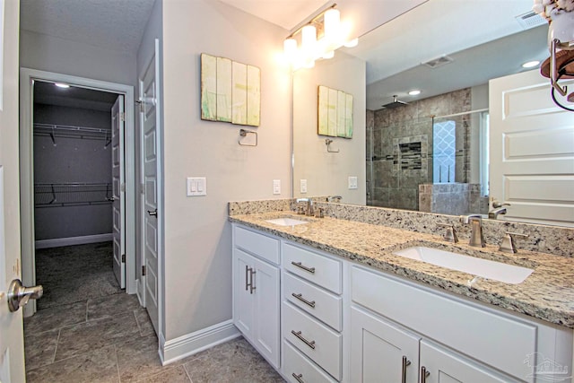 bathroom featuring vanity and tiled shower