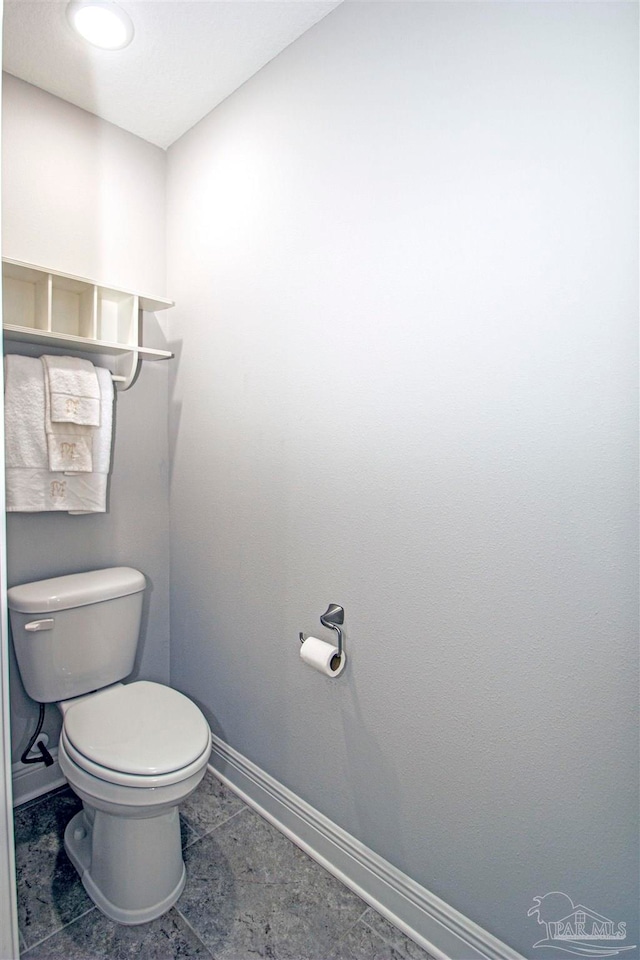 bathroom featuring tile patterned flooring and toilet