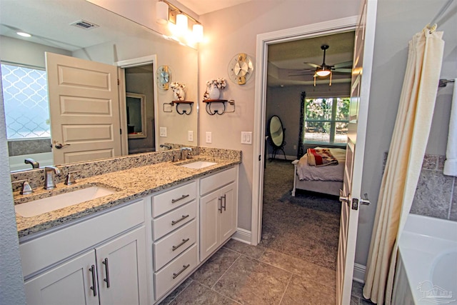 bathroom featuring a tub to relax in, ceiling fan, tile patterned flooring, and vanity