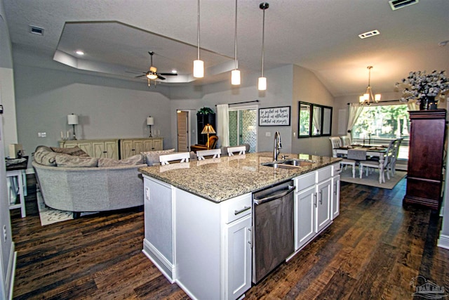 kitchen featuring dishwasher, a kitchen island with sink, ceiling fan with notable chandelier, sink, and white cabinetry