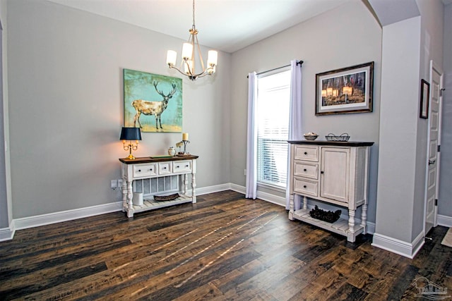 miscellaneous room featuring dark hardwood / wood-style flooring and a notable chandelier