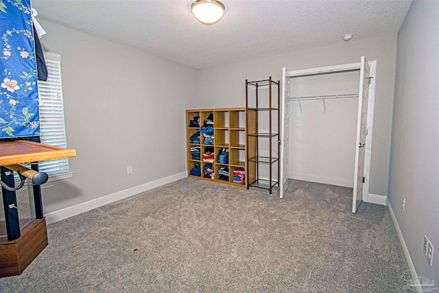 game room with carpet and a textured ceiling