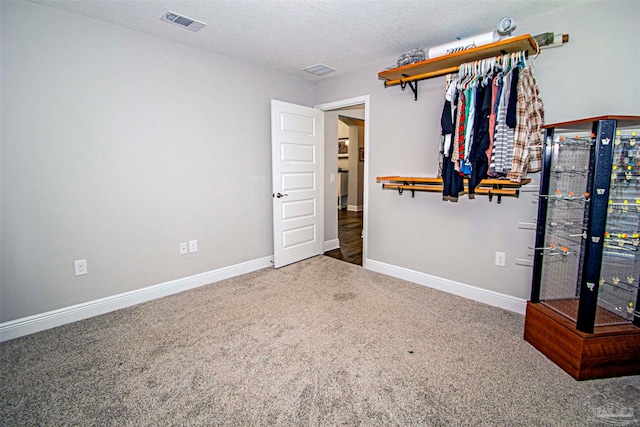 unfurnished bedroom with carpet floors and a textured ceiling