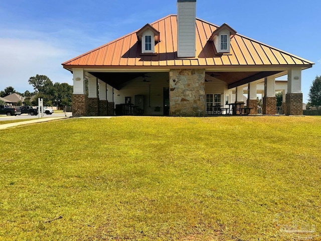 rear view of property featuring a yard