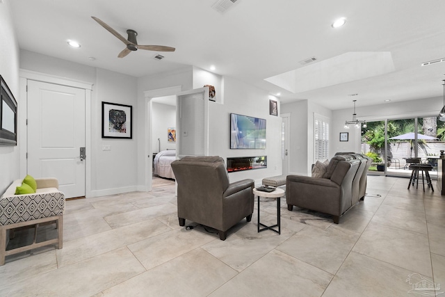 living room with ceiling fan with notable chandelier