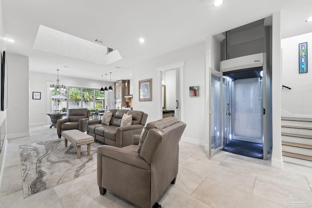 tiled living room featuring an inviting chandelier