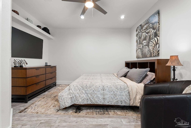 bedroom with ceiling fan and hardwood / wood-style floors