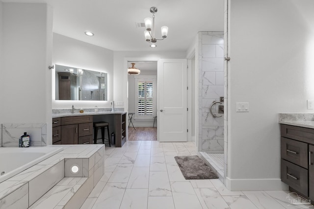 bathroom with vanity, a chandelier, and plus walk in shower