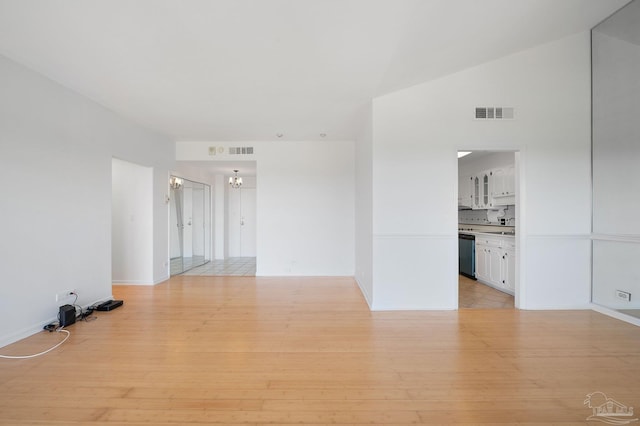 825 Bayshore Dr Unit 1206, Pensacola, FL 32507 - empty room with a chandelier, light wood-style flooring, and baseboards