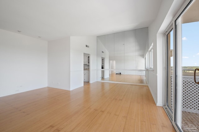 825 Bayshore Dr Unit 1206, Pensacola, FL 32507 - unfurnished room with light wood finished floors, a high ceiling, and baseboards