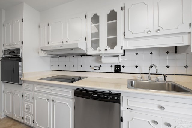 825 Bayshore Dr Unit 1206, Pensacola, FL 32507 - kitchen featuring black appliances, under cabinet range hood, a sink, white cabinets, and decorative backsplash