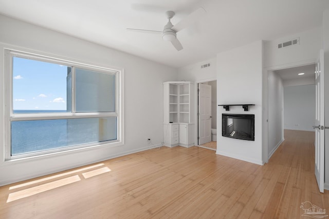 825 Bayshore Dr Unit 1206, Pensacola, FL 32507 - unfurnished living room featuring light wood-style floors, a ceiling fan, a glass covered fireplace, and baseboards