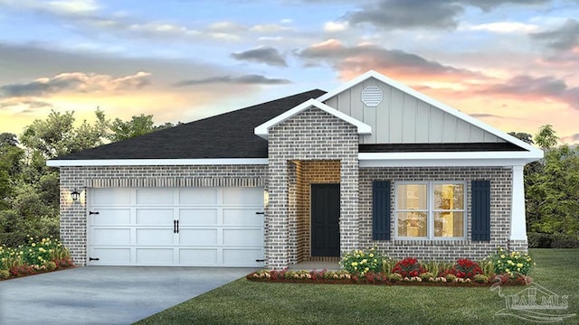 view of front facade with a garage and a lawn