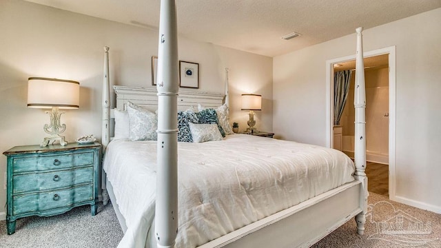 carpeted bedroom featuring a textured ceiling