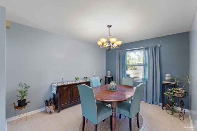 dining area with light tile patterned flooring, baseboards, and an inviting chandelier