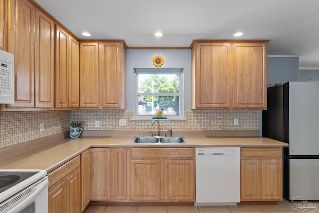 kitchen with light tile patterned floors, white appliances, a sink, tasteful backsplash, and crown molding