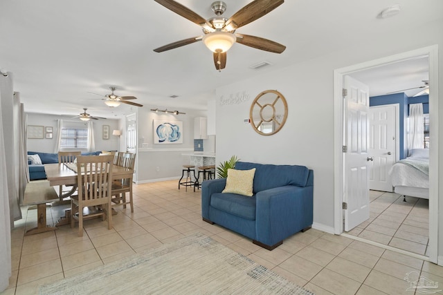 living room with light tile patterned flooring and ceiling fan