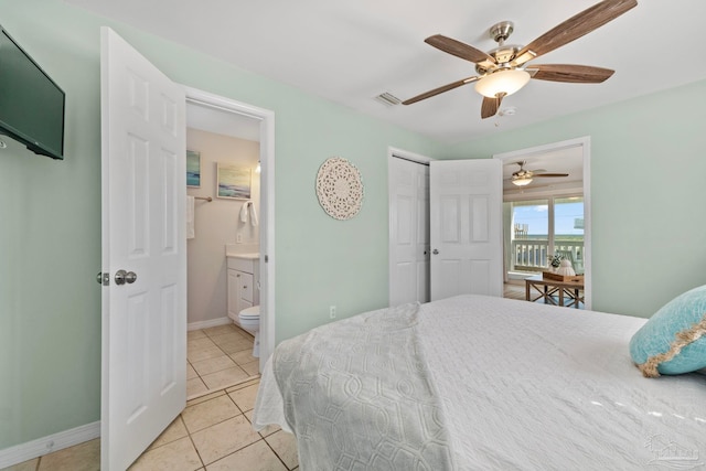 bedroom featuring ceiling fan, a closet, ensuite bath, and light tile patterned floors