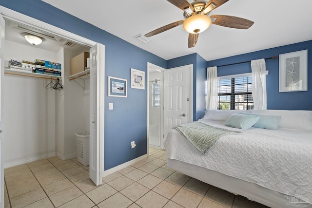 tiled bedroom with ceiling fan and a closet