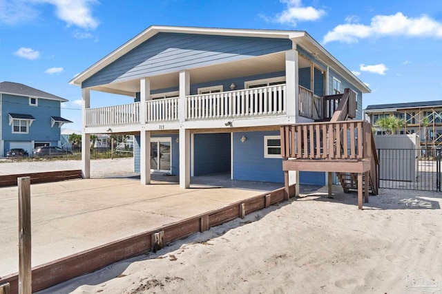 back of house with a deck and a patio area