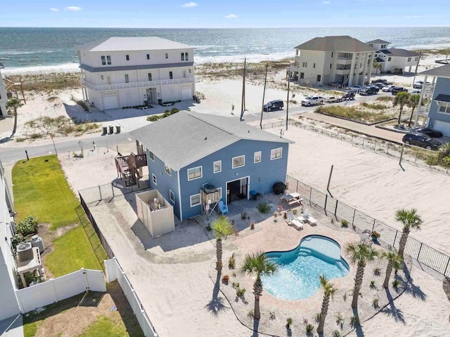 drone / aerial view with a beach view and a water view