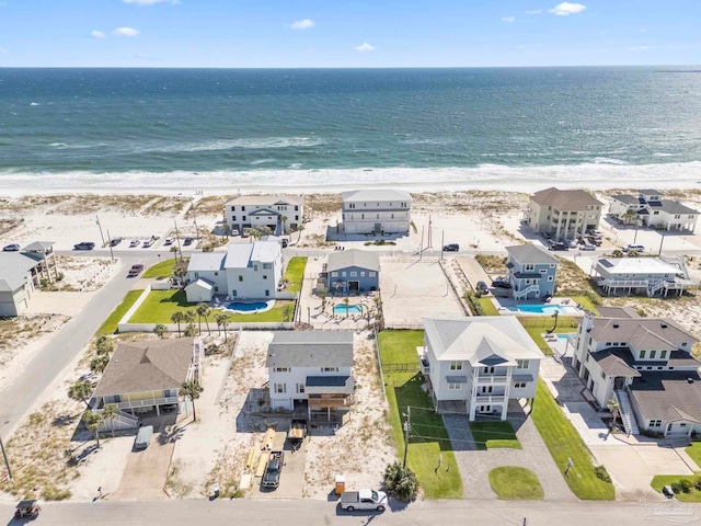 bird's eye view featuring a view of the beach and a water view