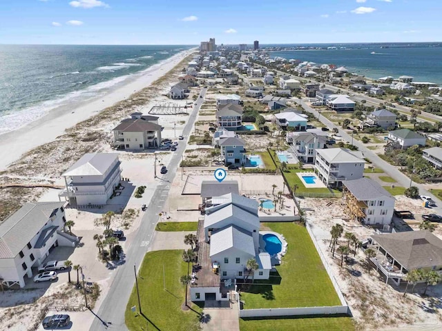 bird's eye view featuring a water view and a beach view