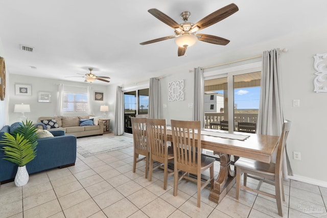 dining area featuring ceiling fan and light tile patterned flooring