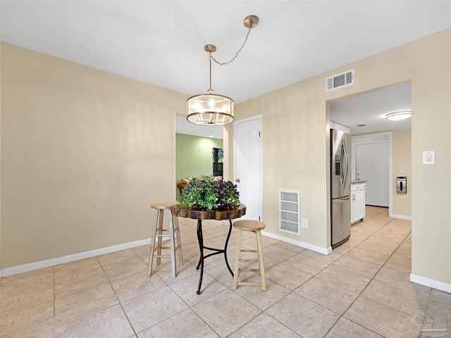 2701 E De Soto St, Pensacola, FL 32503 - dining area with light tile patterned floors, baseboards, and a chandelier
