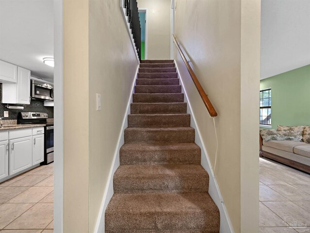 2701 E De Soto St, Pensacola, FL 32503 - stairs featuring tile patterned floors and baseboards