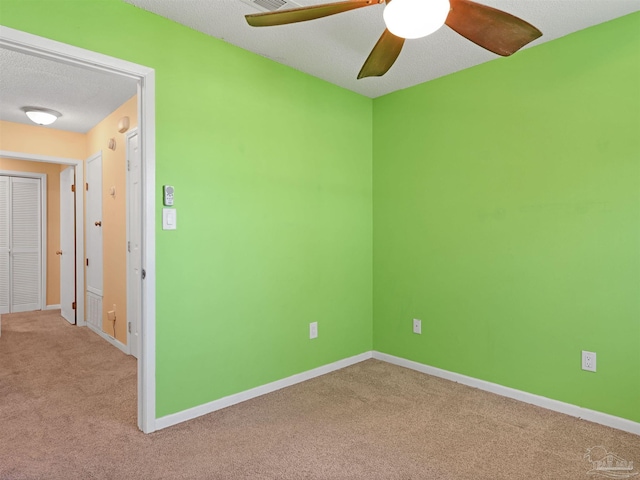 2701 E De Soto St, Pensacola, FL 32503 - empty room with carpet floors, a ceiling fan, baseboards, and a textured ceiling