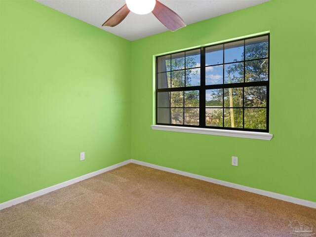 2701 E De Soto St, Pensacola, FL 32503 - carpeted spare room with baseboards and a ceiling fan