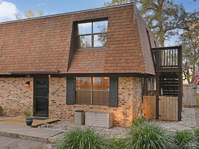 2701 E De Soto St, Pensacola, FL 32503 - view of front of property featuring brick siding, a shingled roof, and fence