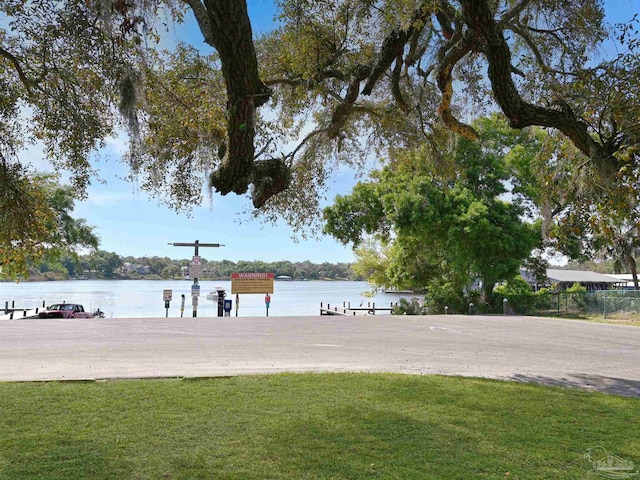 2701 E De Soto St, Pensacola, FL 32503 - view of community featuring a dock, a water view, and a lawn