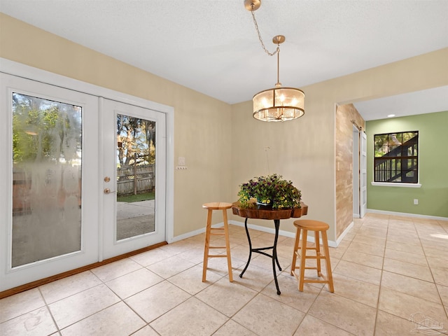 2701 E De Soto St, Pensacola, FL 32503 - dining area featuring light tile patterned floors, baseboards, and a chandelier