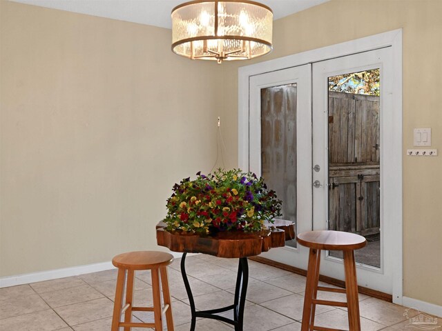 2701 E De Soto St, Pensacola, FL 32503 - dining space with a chandelier, light tile patterned flooring, and baseboards