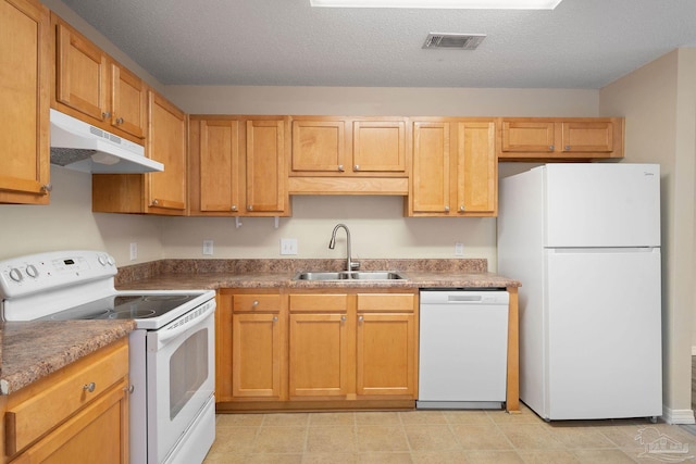 kitchen featuring sink, white appliances, and a textured ceiling