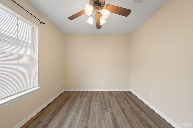 spare room featuring hardwood / wood-style floors and ceiling fan