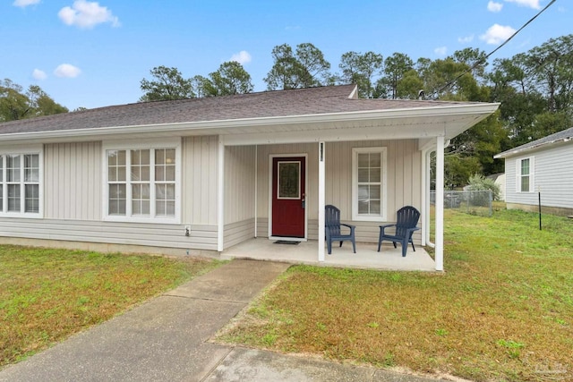 bungalow-style home featuring a porch and a front lawn