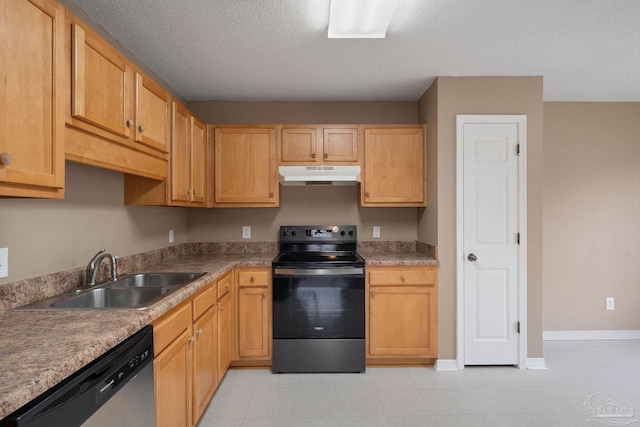 kitchen featuring appliances with stainless steel finishes, sink, light brown cabinets, and a textured ceiling