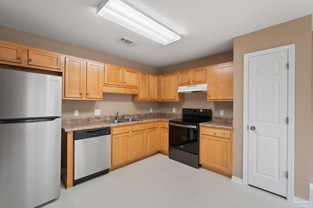 kitchen featuring stainless steel appliances, sink, and light brown cabinets