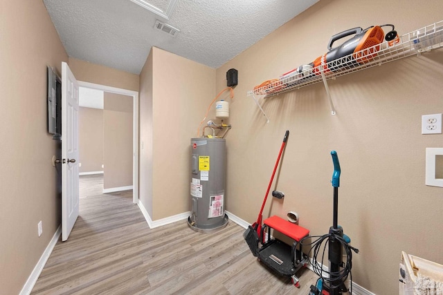 utility room featuring electric water heater