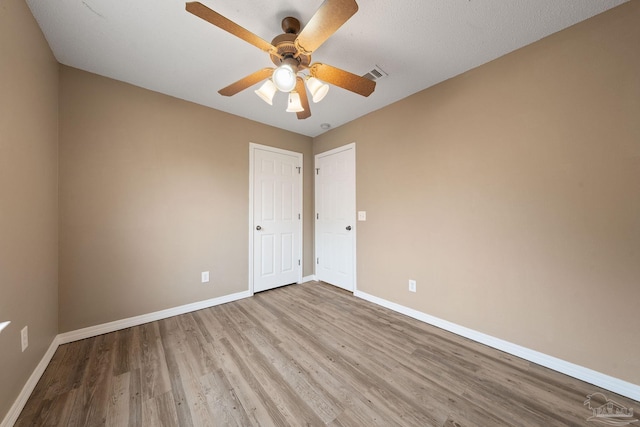 unfurnished room featuring ceiling fan and light wood-type flooring