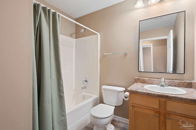 full bathroom with vanity, shower / tub combo, and toilet