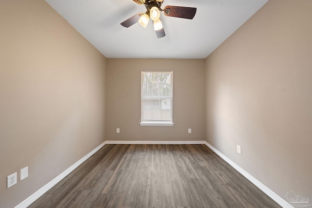 empty room with dark hardwood / wood-style flooring, a textured ceiling, and ceiling fan