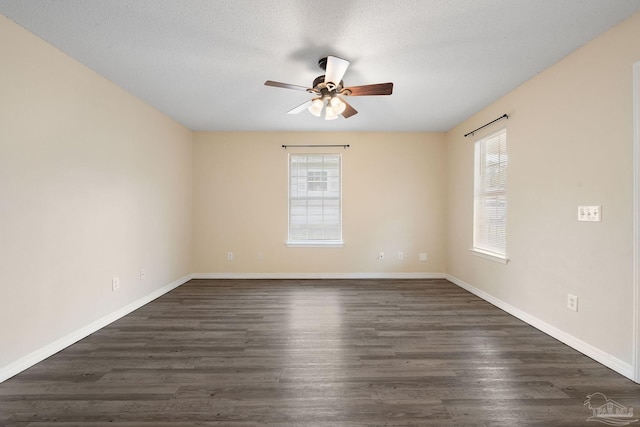 spare room with ceiling fan, dark hardwood / wood-style flooring, and a textured ceiling