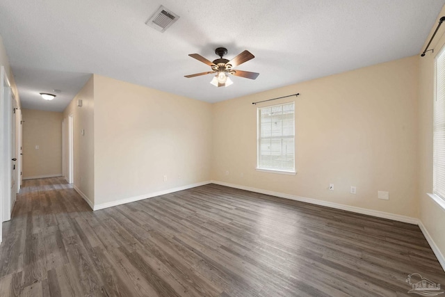 unfurnished room featuring dark hardwood / wood-style floors, a textured ceiling, and ceiling fan