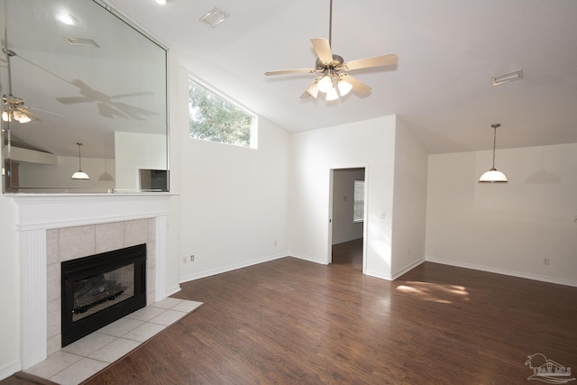 unfurnished living room featuring ceiling fan, lofted ceiling, a fireplace, and hardwood / wood-style floors