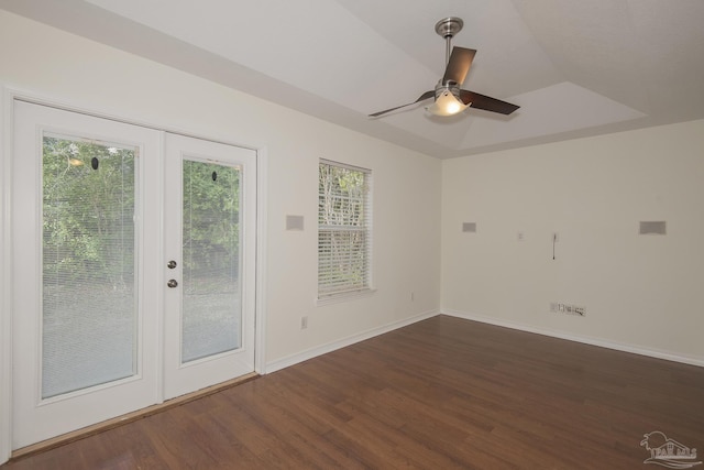 spare room featuring french doors, ceiling fan, a tray ceiling, and dark hardwood / wood-style flooring